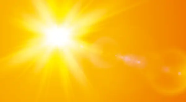 En bländande nysa av solen lyser upp en varm, orange bakgrund med strålar och linsöverstrålning.