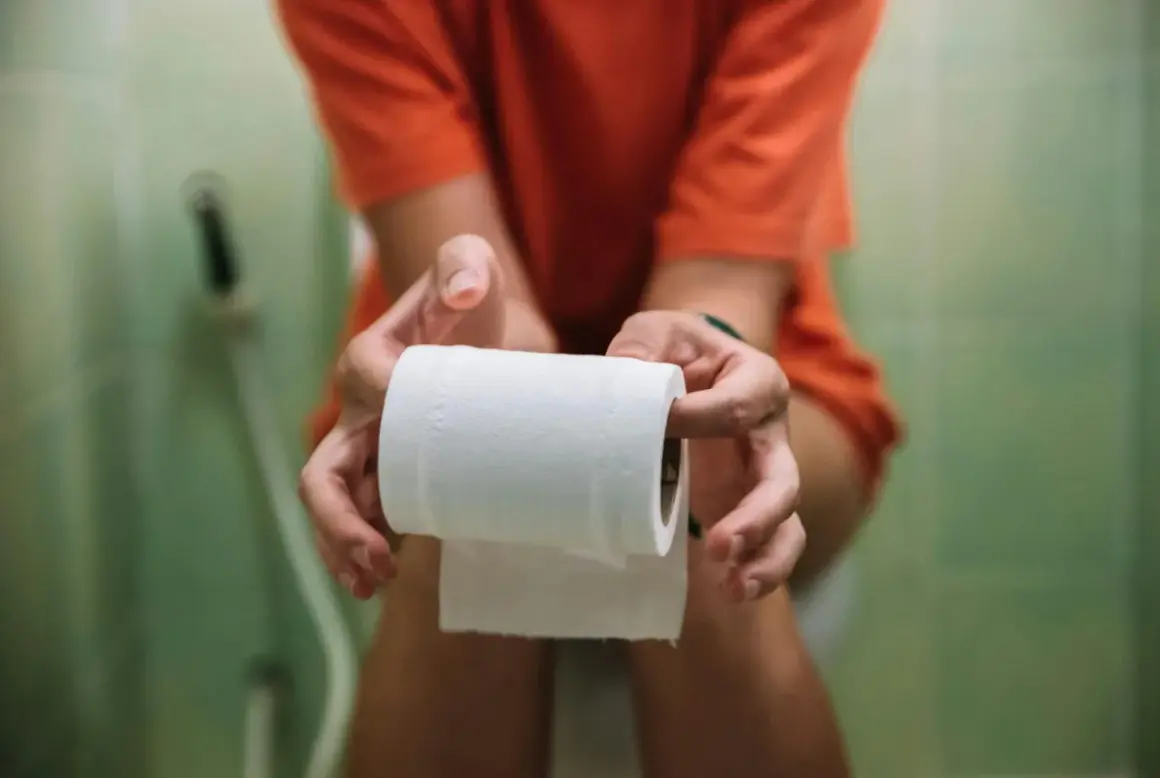 Person håller toalettrulle, kanske för att lindra besvär med ett snabbverkande laxermedel.